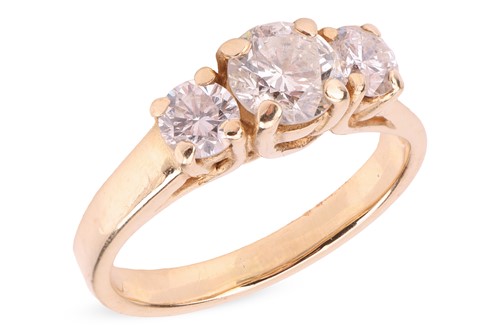 Lot A diamond-set three-stone ring, the central...