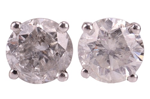 Lot A pair of diamond stud earrings, claw-set with...