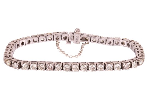 Lot A diamond-set tennis bracelet, set with...