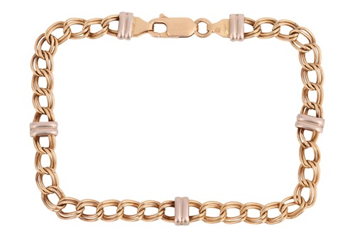 Lot A two-toned double curb link bracelet in 18ct...