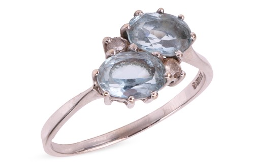 Lot An aquamarine crossover ring in 18ct white...