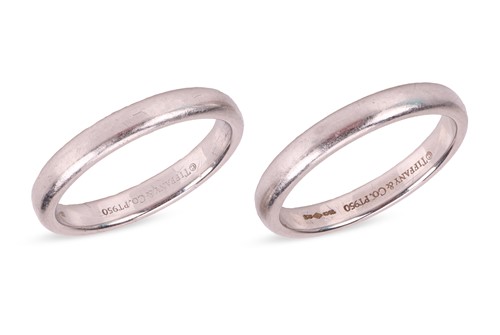 Lot 89 - Tiffany - A pair of platinum band rings by...