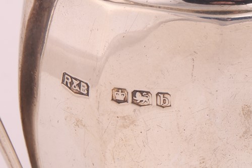 Lot A silver three-piece tea set with a matched...