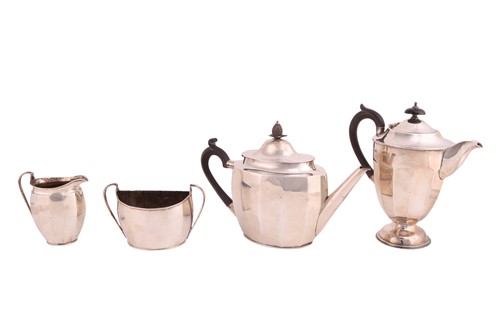 Lot A silver three-piece tea set with a matched...