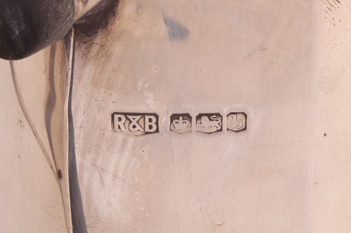 Lot A silver three-piece tea set with a matched...