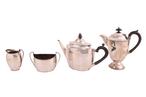 Lot A silver three-piece tea set with a matched...