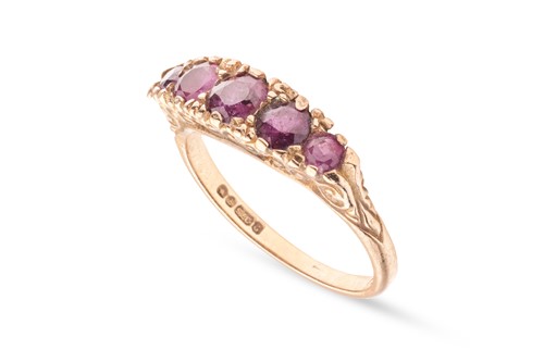 Lot 6 - A ruby five-stone ring in 9ct yellow gold, set...