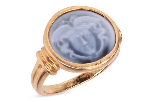 Lot An onyx cameo ring, the round panel carved...