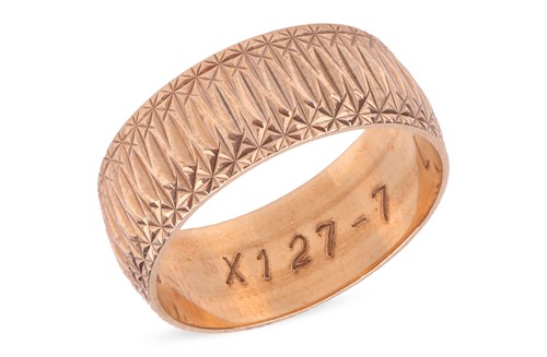 Lot A dress ring in 9ct yellow gold, the wide band...