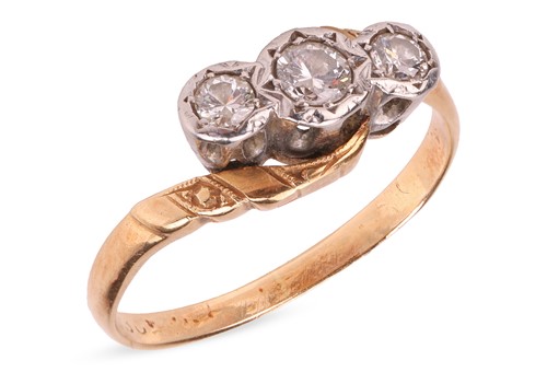 Lot A diamond-set three-stone ring, of crossover...