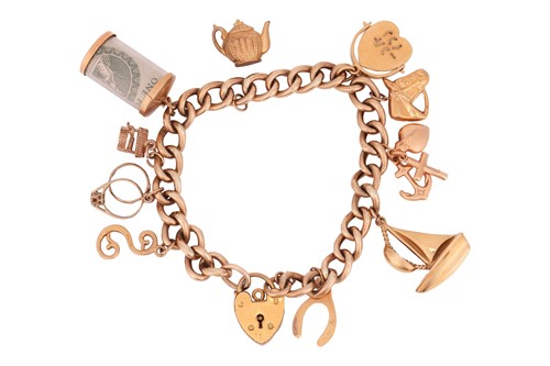 Lot A charm bracelet in 9ct yellow gold,...