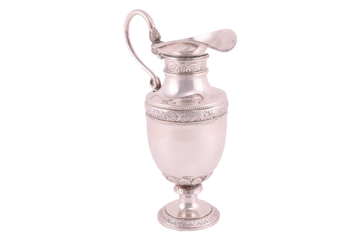 Lot 281 - A white metal ewer, on a spreading foot,