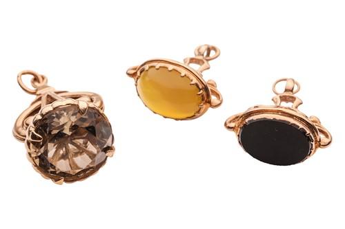 Lot 15 - Three fob seals; claw-set with an onyx plaque,...