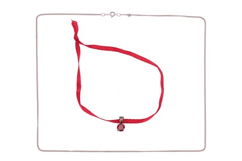 Lot 78 - A garnet-set pendant with chain, claw-set with...