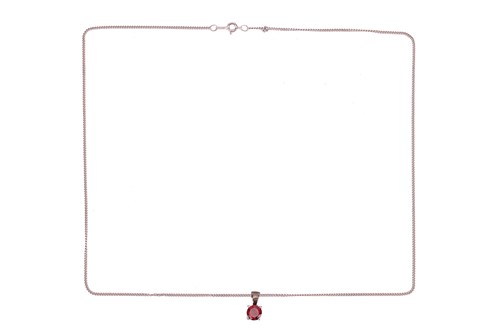 Lot 143 - A garnet-set pendant with chain, claw-set with...