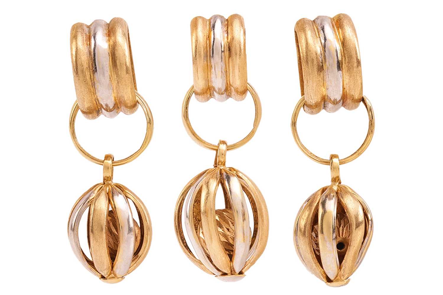 Lot 211 - A two-toned drop pendant and earrings set; of...