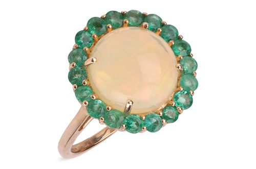 Lot 73 - An opal and emerald cluster ring, the central...