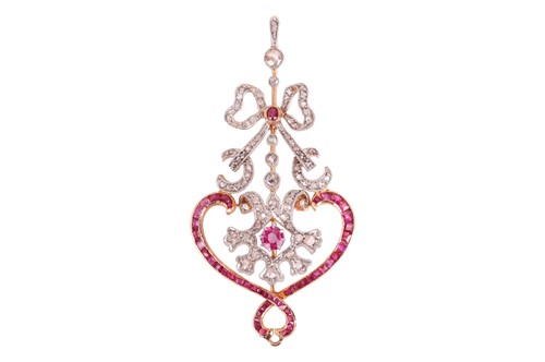 Lot 128 - A ruby and diamond pendant, of openwork scroll...