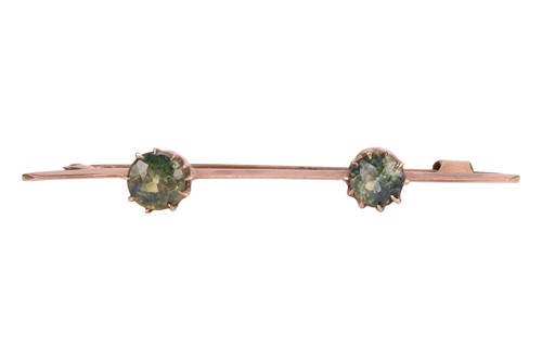 Lot A two-stone green zircon bar brooch, claw-set...