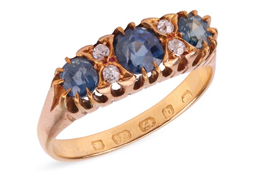 Lot 5 - A sapphire and diamond ring, the graduated...