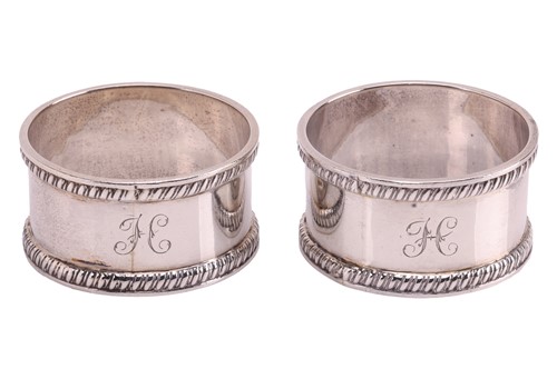 Lot 155 - A pair of cased silver napkin rings, by T H...