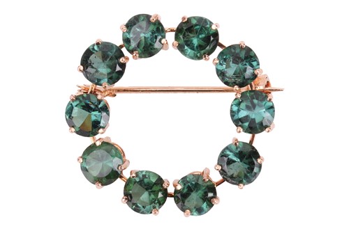 Lot 280 - A tourmaline-set open circle brooch, claw-set...