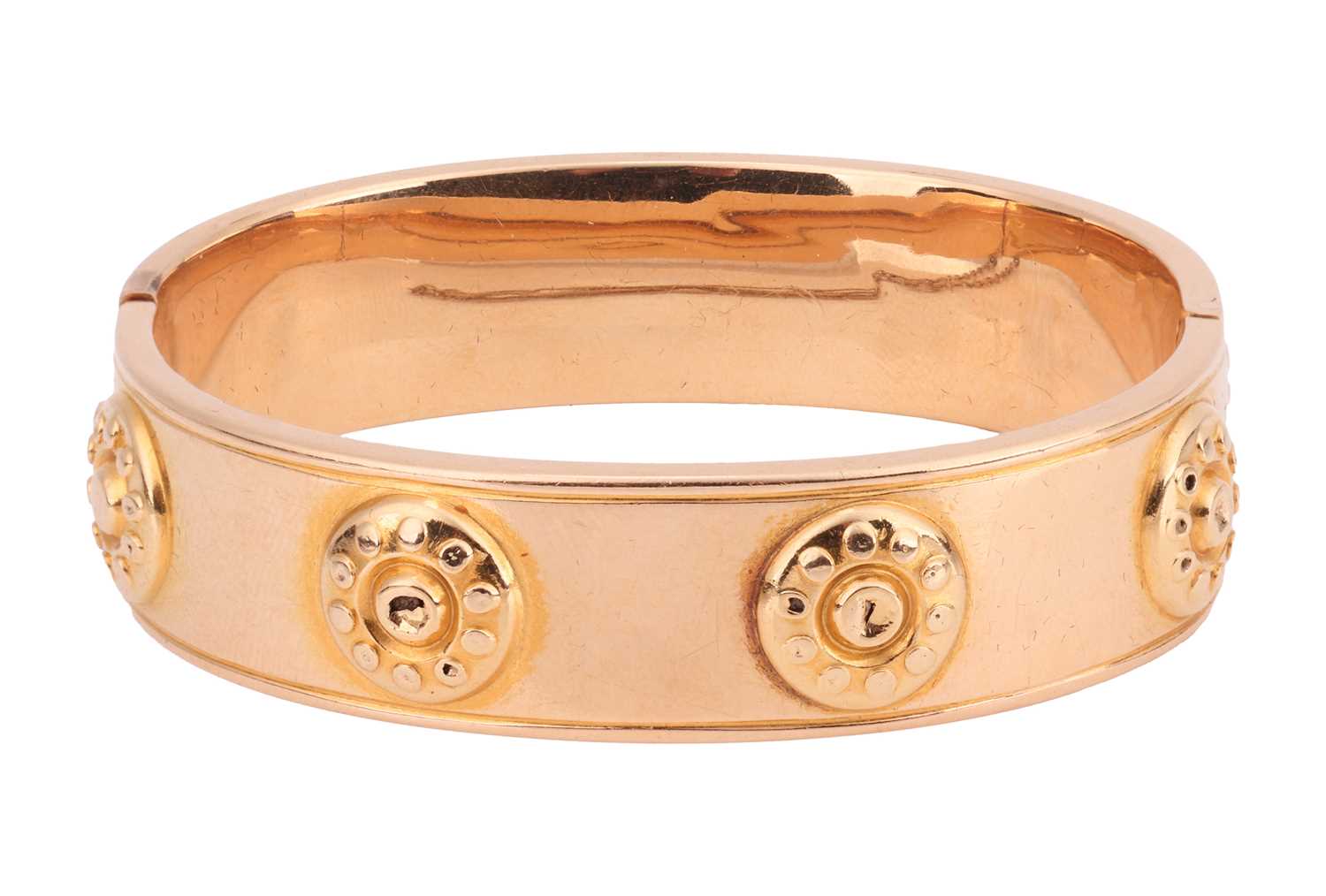Lot 210 - A hollow hinged bangle, the wide band...