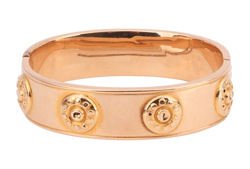Lot 210 - A hollow hinged bangle, the wide band...