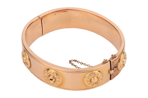 Lot 210 - A hollow hinged bangle, the wide band...