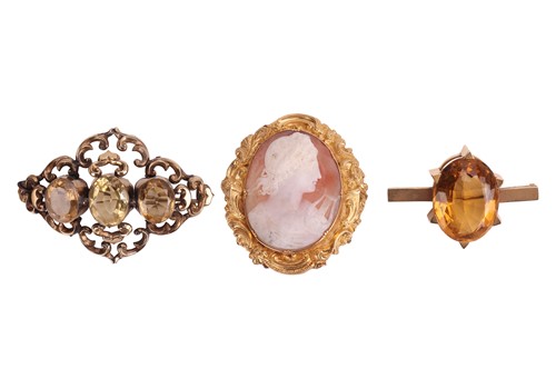 Lot 20 - A shell cameo brooch and two citrine brooches;...