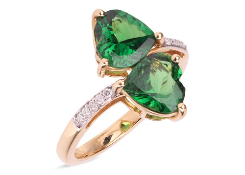 Lot 172 - A tsavorite garnet crossover ring in 18ct gold,...