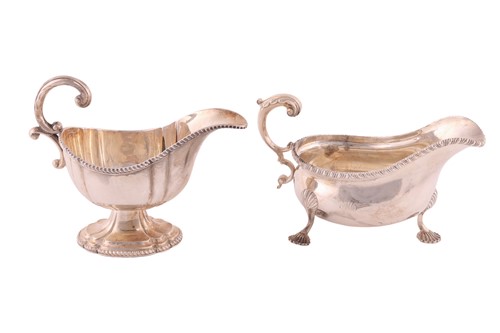 Lot 353 - A George III style sauce boat; with gadrooned...