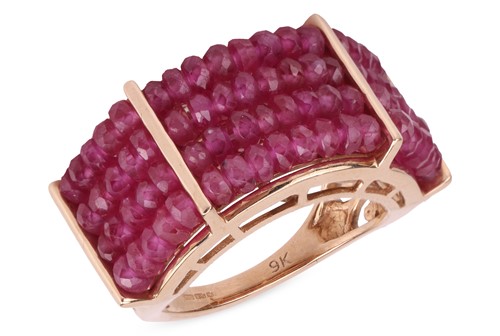 Lot 5 - A ruby bead ring, composed of four rows of...