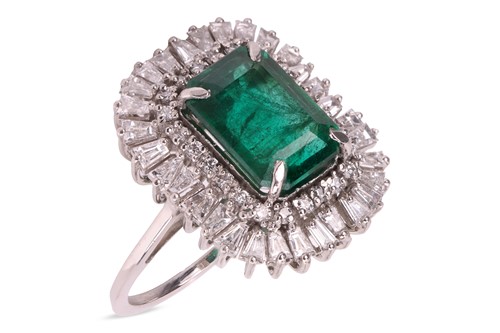 Lot 180 - An emerald and diamond ballerina ring, centred...