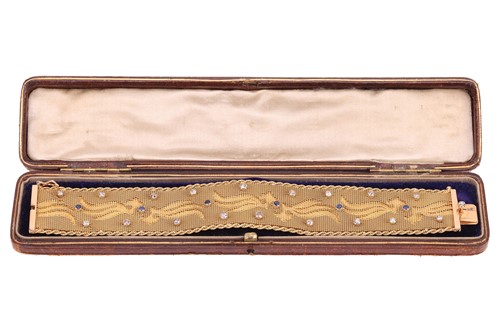 Lot 66 - A woven mesh bracelet with sapphire and...