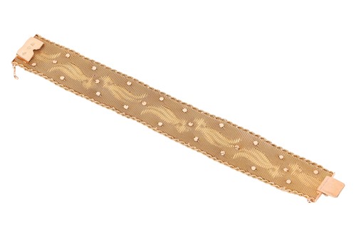 Lot 66 - A woven mesh bracelet with sapphire and...