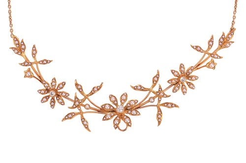 Lot 49 - An Edwardian floral necklace set with split...