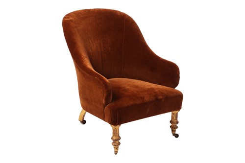 Lot 39 - A fireside armchair, with gilt legs on castors,...