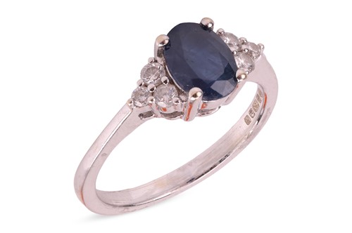 Lot 269 - A sapphire and diamond ring, the four-claw set...