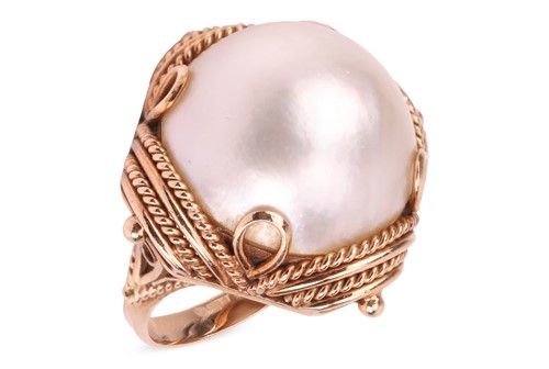 Lot 121 - A mabe pearl cocktail ring, set to a square...