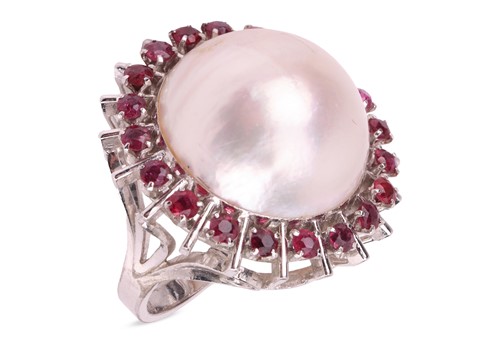 Lot 130 - A large mabe pearl halo ring, set to the...