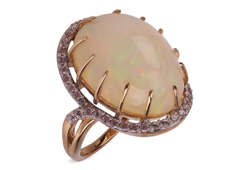 Lot 174 - An Ethiopian opal halo ring in 9ct gold,...