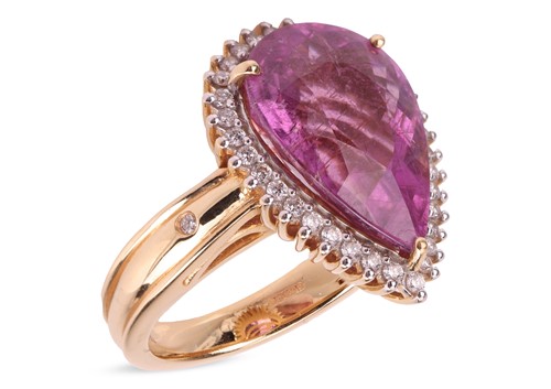 Lot 145 - A rubellite and diamond halo ring in 18ct gold,...