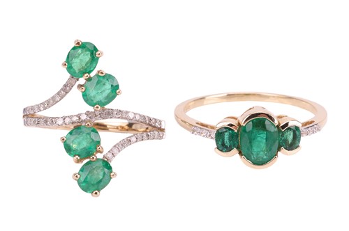 Lot 82 - Two emerald-set rings, comprising a...