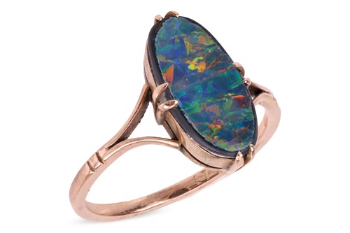 Lot 94 - An opal doublet ring, the claw-set oval-shaped...