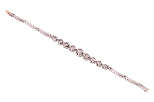 Lot A nine-stone graduated diamond bracelet, with...