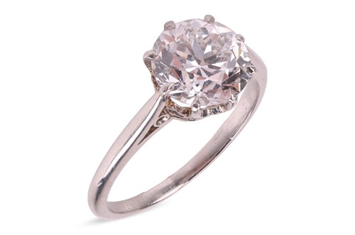 Lot 56 - A transitional-cut diamond solitaire ring,...