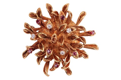 Lot 95 - A stylised flowerhead brooch set with ruby and...