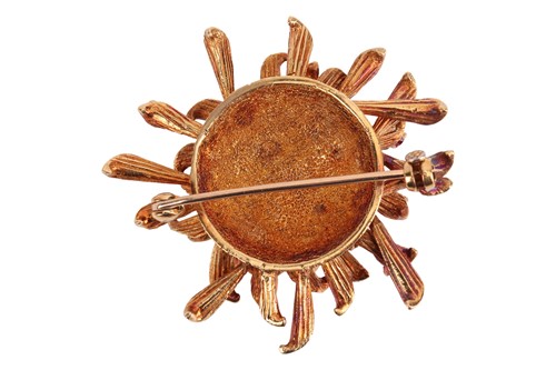 Lot 95 - A stylised flowerhead brooch set with ruby and...