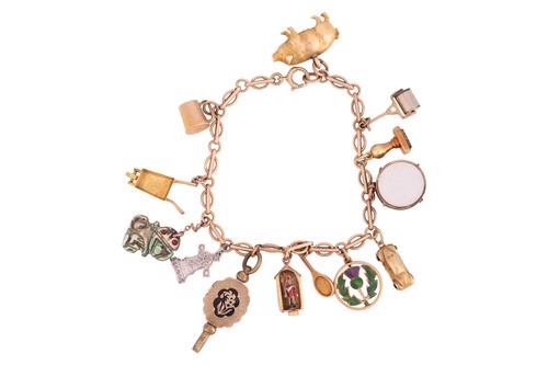 Lot 110 - A charm bracelet, the fancy-link chain stamped...